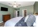 This stylish bedroom includes a modern dresser, walk-in closet, and private ensuite bathroom at 11142 Spring Point Cir, Riverview, FL 33579