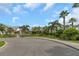 Attractive community entrance featuring lush landscaping, palm trees, and manicured lawns at 11142 Spring Point Cir, Riverview, FL 33579