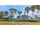 Lucaya Lake Club entrance featuring a decorative tower, clear blue signage, and mature palm trees at 11142 Spring Point Cir, Riverview, FL 33579