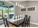 Bright dining room with sliding glass door to the backyard and view of decorative wall art at 11142 Spring Point Cir, Riverview, FL 33579