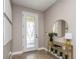Light-filled foyer with decorative glass door, stylish console table, and neutral decor at 11142 Spring Point Cir, Riverview, FL 33579