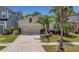 Inviting single-Gathering home featuring a neutral exterior, attached garage, and lush landscaping at 11142 Spring Point Cir, Riverview, FL 33579