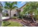 Attractive home with a well-kept lawn, stone accents, and mature landscaping at 11142 Spring Point Cir, Riverview, FL 33579