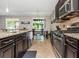 Galley kitchen featuring stainless steel appliances, dark cabinets, and granite countertops at 11142 Spring Point Cir, Riverview, FL 33579