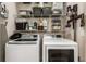 Well-equipped laundry room with a front load washer and dryer and ample storage at 11142 Spring Point Cir, Riverview, FL 33579