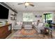 Spacious living room featuring a comfortable sectional sofa, decorative shelves, and a bright window at 11142 Spring Point Cir, Riverview, FL 33579