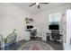 Versatile home office featuring dual workstations, a ceiling fan, and ample natural light at 11142 Spring Point Cir, Riverview, FL 33579