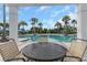 Relaxing poolside view with lounge chairs and palm trees, perfect for enjoying sunny days at 11142 Spring Point Cir, Riverview, FL 33579