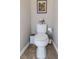 Cozy half-bathroom featuring a modern toilet, tile floors, and fresh decor at 11142 Spring Point Cir, Riverview, FL 33579