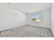 Bedroom with carpet, natural light from large window, and neutral color scheme at 11447 Shoreline Trl, Parrish, FL 34219