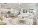 Bright, open-concept living room featuring modern decor and a seamless transition to the stylish kitchen at 11447 Shoreline Trl, Parrish, FL 34219