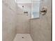 Modern tiled shower featuring a glass partition and sleek fixtures at 11447 Shoreline Trl, Parrish, FL 34219
