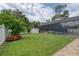 Spacious backyard with a screened pool area, lush lawn, and vibrant landscaping at 12610 Eagles Entry Dr, Odessa, FL 33556