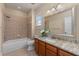 Bathroom featuring a bathtub and shower with a wooden vanity and marble countertops at 12610 Eagles Entry Dr, Odessa, FL 33556