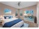 Well-lit bedroom featuring a queen-sized bed, coastal decor, and lots of natural light at 12610 Eagles Entry Dr, Odessa, FL 33556