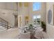 Formal dining room featuring tile floors, staircase, and many windows at 12610 Eagles Entry Dr, Odessa, FL 33556