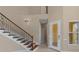 Elegant foyer showcasing a wood staircase, neutral paint, and arched doorways at 12610 Eagles Entry Dr, Odessa, FL 33556