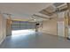 An empty two-car garage with a gray floor and an open garage door showing the driveway at 12610 Eagles Entry Dr, Odessa, FL 33556