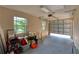Bright garage with two windows, a grey floor, and an automatic garage door at 12610 Eagles Entry Dr, Odessa, FL 33556