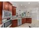 Well-equipped kitchen featuring granite countertops, stainless steel appliances, and an open layout at 12610 Eagles Entry Dr, Odessa, FL 33556