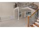 Spacious living area featuring a staircase with decorative iron and a view of the outdoor pool at 12610 Eagles Entry Dr, Odessa, FL 33556