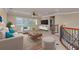 A cozy living room with a ceiling fan, a plush sofa, and a wooden coffee table on the carpet at 12610 Eagles Entry Dr, Odessa, FL 33556