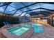 An enticing pool features a spa, fountains, blue umbrellas, and an extended patio at 12610 Eagles Entry Dr, Odessa, FL 33556