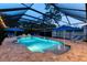 A stunning screened pool features a spa, water features, lounge chairs, and night lighting at 12610 Eagles Entry Dr, Odessa, FL 33556