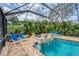 Relaxing screened pool and spa with ample seating and tropical landscaping at 12610 Eagles Entry Dr, Odessa, FL 33556
