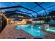 The refreshing pool area features a spa, patio, umbrellas, and screened enclosure at 12610 Eagles Entry Dr, Odessa, FL 33556