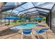 Lovely screened pool area with comfortable lounge chairs and sunny umbrellas at 12610 Eagles Entry Dr, Odessa, FL 33556