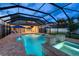 A refreshing pool with spa, water features, umbrellas, patio, and screen enclosure at 12610 Eagles Entry Dr, Odessa, FL 33556