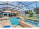 Wonderful screened pool with spa, umbrellas, and lush backyard views at 12610 Eagles Entry Dr, Odessa, FL 33556