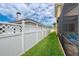 Side yard with a white fence and well-maintained landscaping at 12610 Eagles Entry Dr, Odessa, FL 33556
