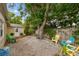 Spacious backyard with lounge chairs and a mature shade tree at 130 41St Ne Ave, St Petersburg, FL 33703