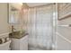Updated bathroom with modern vanity, glass bowl sink, and tiled shower with curtain at 130 41St Ne Ave, St Petersburg, FL 33703