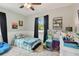 Cozy bedroom with playful decor, ceiling fan, and a window with black out curtains at 130 41St Ne Ave, St Petersburg, FL 33703