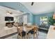 The dining area flows into the living room with natural lighting, wooden furniture and stylish accents at 130 41St Ne Ave, St Petersburg, FL 33703