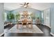 A dining room features blue walls, a ceiling fan, a table with four chairs and a decorative painting above a sideboard at 130 41St Ne Ave, St Petersburg, FL 33703
