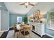 Dining area showcasing a wooden table, updated lighting and large windows for natural light at 130 41St Ne Ave, St Petersburg, FL 33703