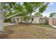Sweet single-story house boasting neat landscaping and a beautiful tree at 130 41St Ne Ave, St Petersburg, FL 33703