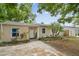 Quaint single-story house displaying neat landscaping, light beige paint and a driveway at 130 41St Ne Ave, St Petersburg, FL 33703