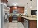 Modern kitchen with stainless steel appliances, granite countertops, and wood cabinetry at 130 41St Ne Ave, St Petersburg, FL 33703