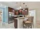 Gourmet kitchen with stainless steel appliances, granite countertops, and a breakfast bar area at 130 41St Ne Ave, St Petersburg, FL 33703