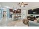 Spacious open-concept features tile floors, modern lighting, ceiling fan and transitions to kitchen bar seating at 130 41St Ne Ave, St Petersburg, FL 33703