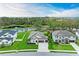 Stunning aerial view of a modern home with a lake view and well-manicured lawn at 13034 Bliss Loop, Bradenton, FL 34211