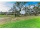 Expansive backyard featuring a mix of grassy areas and natural growth with mature trees, offering space and privacy at 13034 Bliss Loop, Bradenton, FL 34211