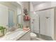 Bathroom featuring granite countertop, sink, toilet, and a glass enclosed shower at 13034 Bliss Loop, Bradenton, FL 34211