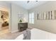 Bright bedroom with shuttered windows, artwork, and soft gray carpet at 13034 Bliss Loop, Bradenton, FL 34211