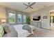 Cozy bedroom featuring soft carpet, lots of natural light, and a comfortable bed at 13034 Bliss Loop, Bradenton, FL 34211